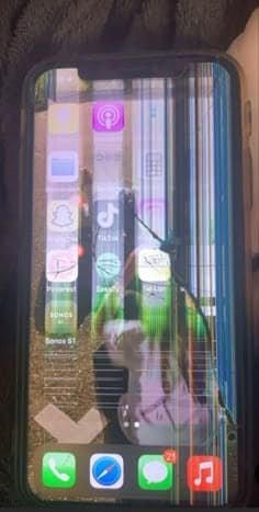 iPhone with distorted icons and screen dimming caused by internal damage