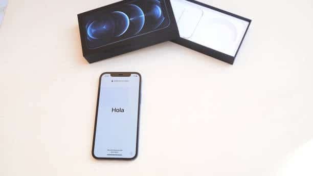 iPhone 12 displaying “Hola” on screen during initial setup process