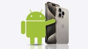 Android robot standing next to an iPhone 15 Pro illustrating cross-platform refresh rate discussion