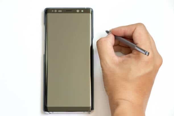 Samsung phone with black screen and stylus indicating touch or screen failure